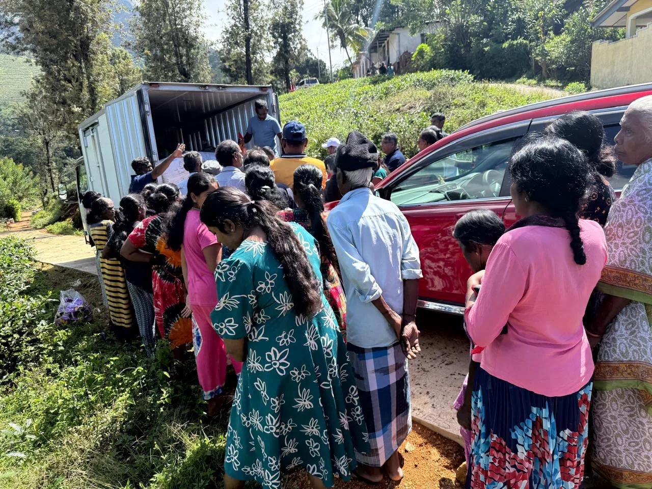 A crowd of hill-country residents gathered at the back of a relief truck to receive supplies.